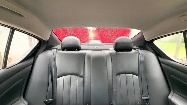 A driver's point of view inside a car wash. Back view