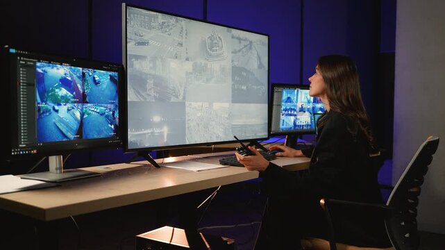Security officer monitoring cctv footage in control room