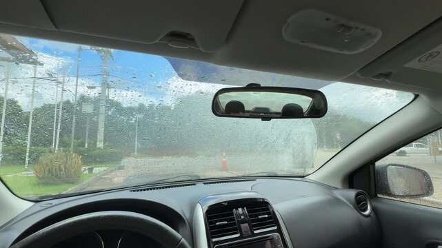A driver's point of view inside a car wash. Front view