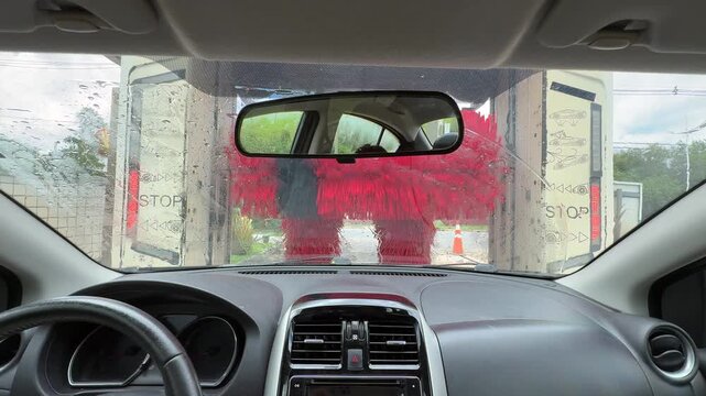 A driver's point of view inside a car wash. Front view