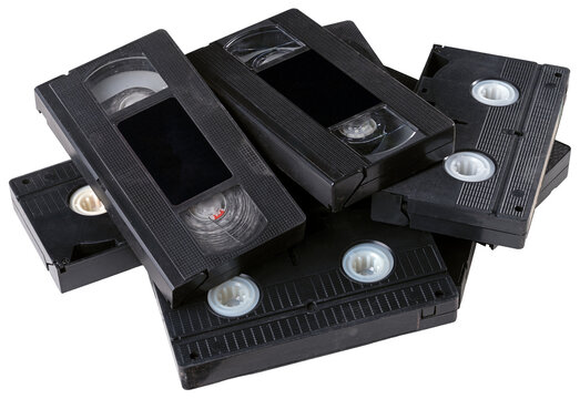 Several VHS tapes lying in a loose stack. Isolated background.