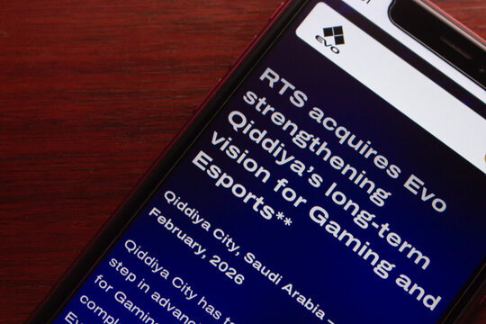 Quito, ECUADOR - Feb 23 2026 : Angled close-up of smartphone showing EVO news article about RTS acquisition, Qiddiya esports vision, and gaming industry expansion online today.