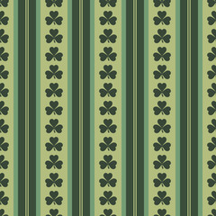 St. Patrick's Day seamless green shamrock pattern with vertical stripes. Lucky clover background for Irish holiday celebrations, festive wallpaper, scrapbooking, and March 17th event designs.
