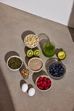 High angle view of different types of superfood kept on floor