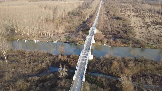 Aerial view of a metal bridge crossing the Tamis river in a winter landscape
