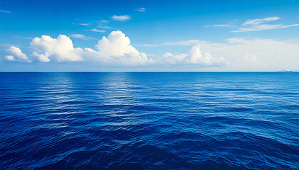 Fototapeta premium A vast expanse of clear blue sky stretches across the frame, transitioning smoothly 