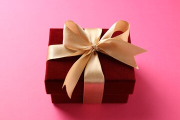 Elegant velvet gift box on pink background, closeup