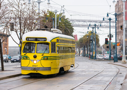USA, CA, San Francisco.  Vintage yellow trolley bus in the Mission District.
