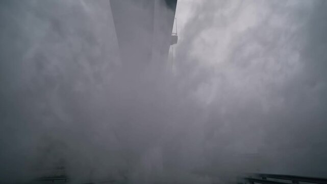 Foggy bridge view, Hidden crossing shrouded in mist, Secluded overpass cloaked by thick fog and columns, Secluded passageway over bridge is hidden beneath heavy cloud of fog and mist