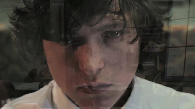 A time-lapse of a young Caucasian man thinking about himself typing on a computer with flashback