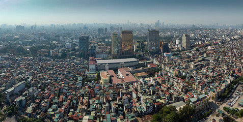 Hanoi, Vietnam: Aerial panorama of the dense urban sprawl, blending modern high-rises with traditional housing under a hazy sky. © Zenstratus