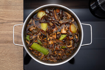 Polish cuisine wild mushroom soup cooking in pot