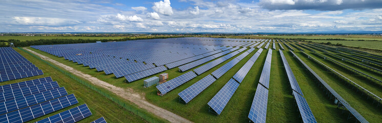 Aerial view of large sustainable electrical power plant with rows of solar photovoltaic panels for producing clean electric energy. Concept of renewable electricity with zero emission © bilanol