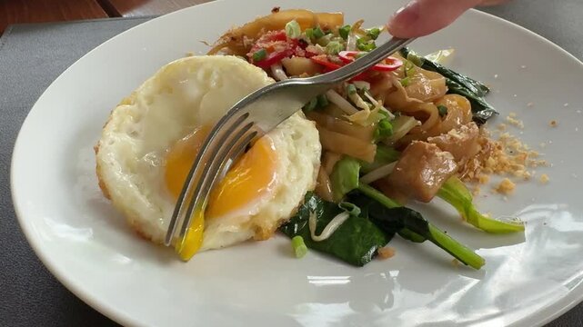 Eating a Fried Egg with Noodles