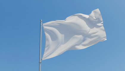 White flag waving in the wind against a clear blue sky.