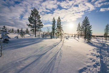 Hiking to the summit of Mount Kiilopää during a spectacular arctic sunset in Finnish Lapland. © julen