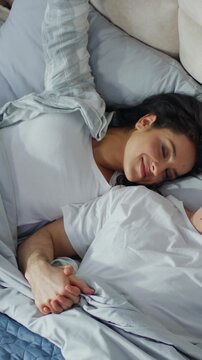 Happy Caucasian couple man woman sleeping together on bed home bedroom daydream lovers sleep cozy wake up weekend rest napping soft mattress apartment wife husband sweetheart intimacy hugging marriage