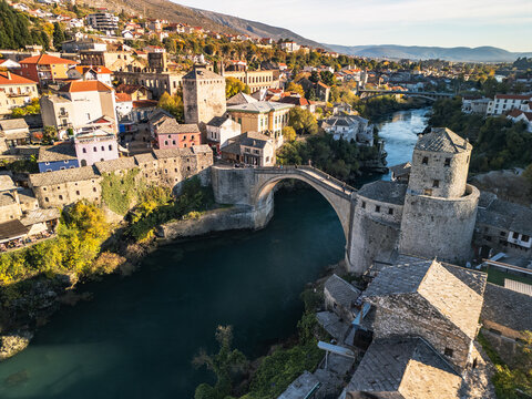 Aerial view of Stari Most (Old Bridge) and Neretva river in Mostar at sunset, Bosnia and Herzegovina. Iconic UNESCO world heritage site and ottoman architecture panorama.