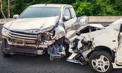 A vintage black luxury automobile sits as a broken 4x4 wreck and abandoned transportation vehicle, a classic old car crash left on the desert road with a cracked wheel and rusty frame