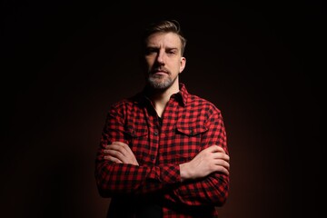 Obraz premium Brutal man with beard on dark background