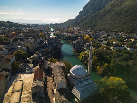 Aerial 4K view of the Koski Mehmed Pasha Mosque and Stari Most bridge at sunrise, Mostar, Bosnia and Herzegovina