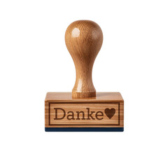 A wooden stamp with the german word 'danke' and a heart symbol