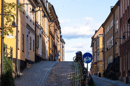 Uphill cobblestone roadway leads through historic urban architecture on a street with Sodermalm facade in Stockholm Sweden near a Scandinavia building