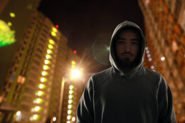 Fototapeta premium Criminal in hooded sweatshirt in city at night