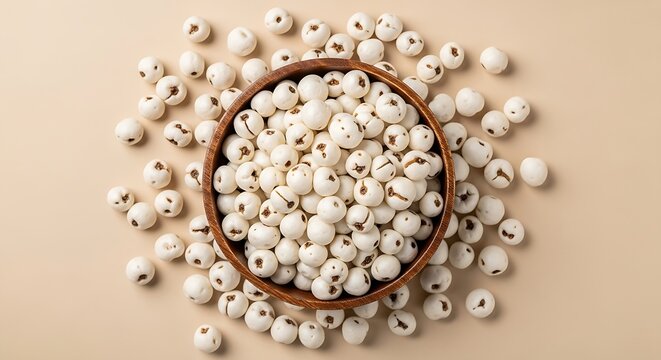 Authentic popped lotus seeds in a dark wood bowl, perfect for healthy snacking and traditional Indian recipes.
