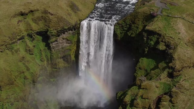 Aerial view of a majestic waterfall with a rainbow
