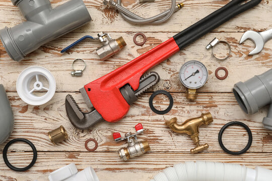 Composition with plumber's items on white wooden background