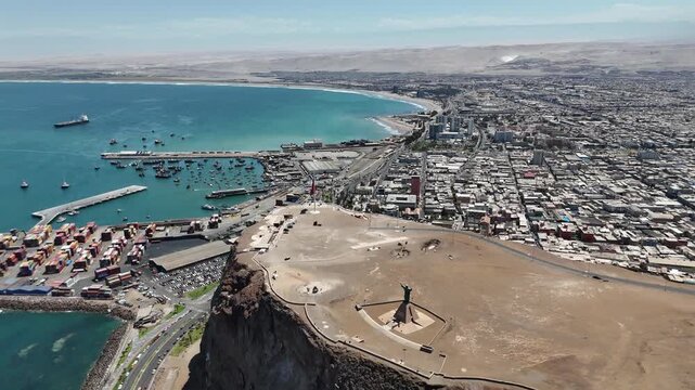 Aerial 4K view of Morro de Arica, sunny day over the Pacific Ocean coast and historical landmark. Chile