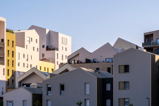 Modern apartments buildings architecture with residential rooftops over neighborhood streets in Port Marianne Montpellier France during daylight