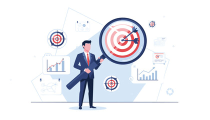 Businessman holding a large magnifying glass focusing on a target with arrows in the bullseye, surrounded by business charts and graphs, representing goal setting, market analysis, and achievement. © JohnLester