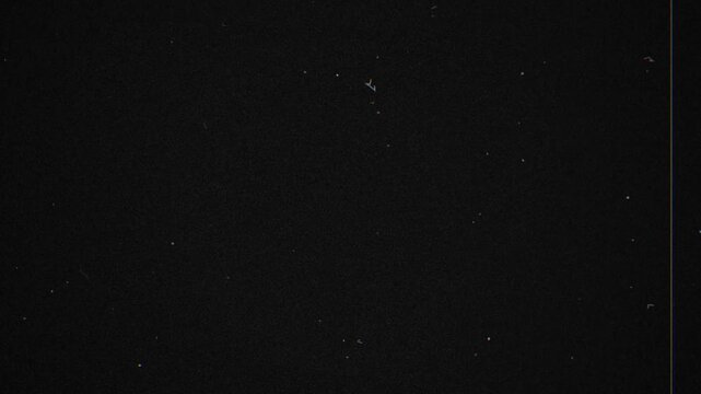 Black background animation with white speckles creating stark contrast