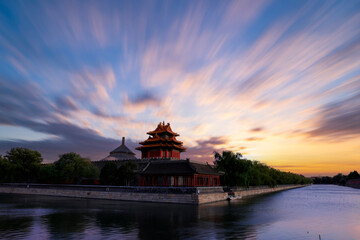 Obraz premium The corner towers of the Forbidden City in China and the beautiful sunset glow at dusk.