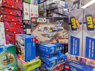 Fototapeta premium Canada, Montreal, 22 December 2025 : Lego Star Wars set surrounded by various colorful toy boxes