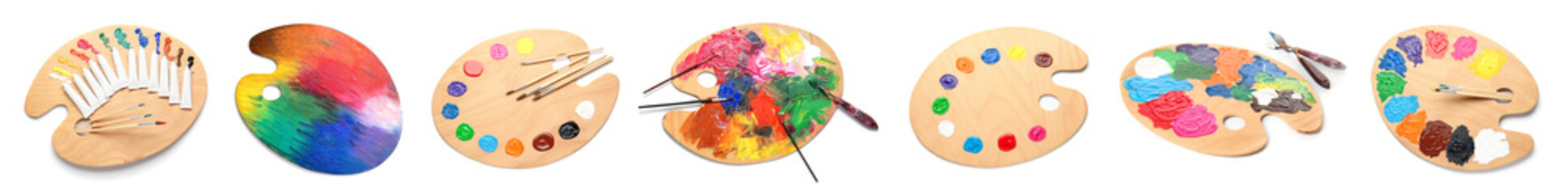Set of artist's palettes and brushes on white background