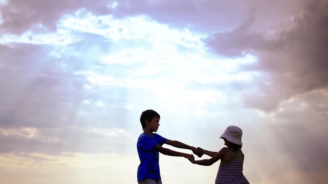 Playful Dance Under the Evening Sky: Boy and Girl Sharing Joyful Moments Together