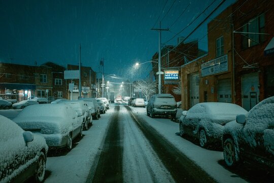 Snowy street scene with vintage Authorized Motor Service on a snowy winter night, Philadelphia, Pennsylvania