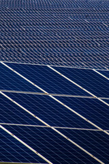 Blue photovoltaic solar panels on a roof. This image captures the intricate pattern of clean energy technology, symbolizing sustainability, renewable power, and green innovation for the future.