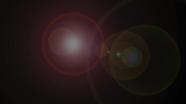 Large HD beautiful abstract lens flare on a dark black background slowly animated in upward motion