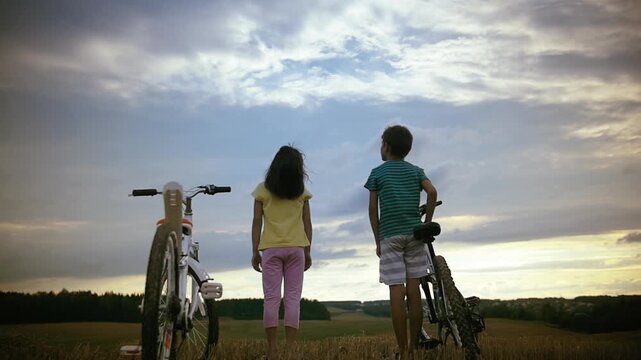 Sunset Bonding: Children Embracing After an Adventurous Bike Ride in the Field