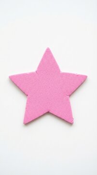 Pink craft foam star on a clean white surface dcd