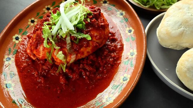 Authentic Mexican street food served in a clay plate, red pambazo