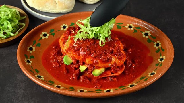 Placing chopped lettuce on top of a chancla poblana or Mexican pambazo, Mexican Food