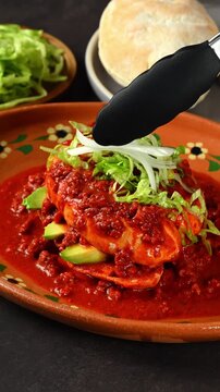 Placing sliced ​​onions on top of a chancla poblana or Mexican pambazo, Mexican traditional food