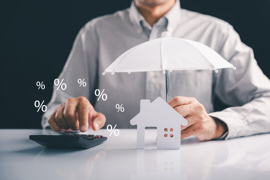 Protect your house and finance with an umbrella, keeping it safe from rates, showing investment and a lover concept, the property is really well insured if you are insured