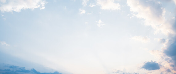 the sky is clear blue with fluffy white clouds, the sky is very bright, and the sun shines.