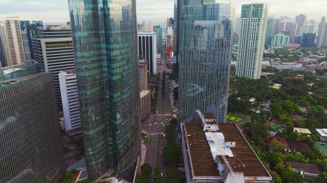 Slow forward drone over Ayala Triangle morning junction, Makati, Philippines